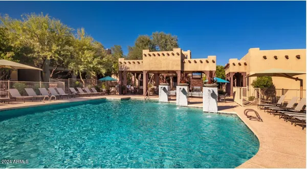 a view of a swimming pool with outdoor seating