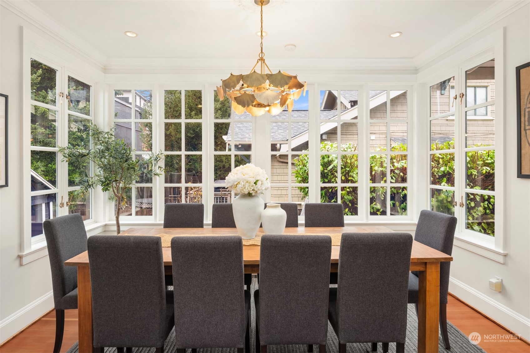 3206 East Terrace Street Seattle, WA 98122 - Photo 14 of 28 a view of a dining room with furniture large windows and wooden floor