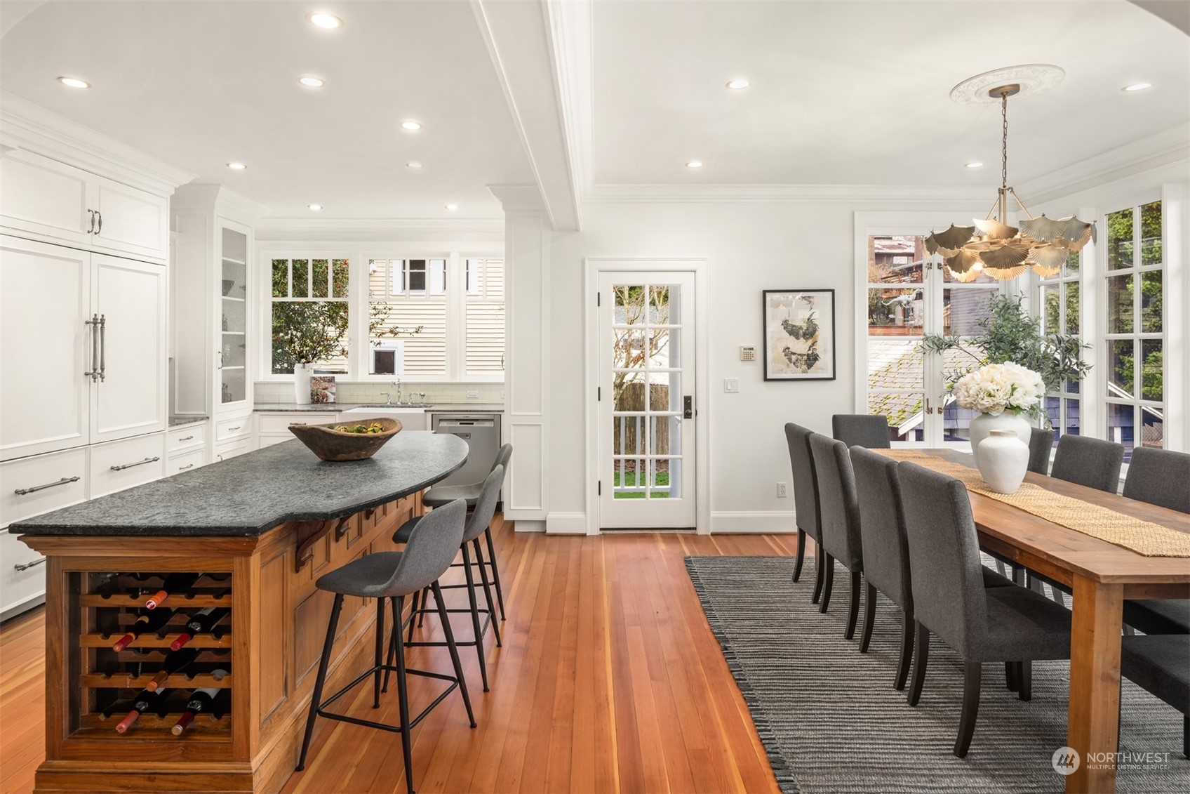 3206 East Terrace Street Seattle, WA 98122 - Photo 9 of 28 a dining room with stainless steel appliances kitchen island granite countertop a dining table chairs and couches