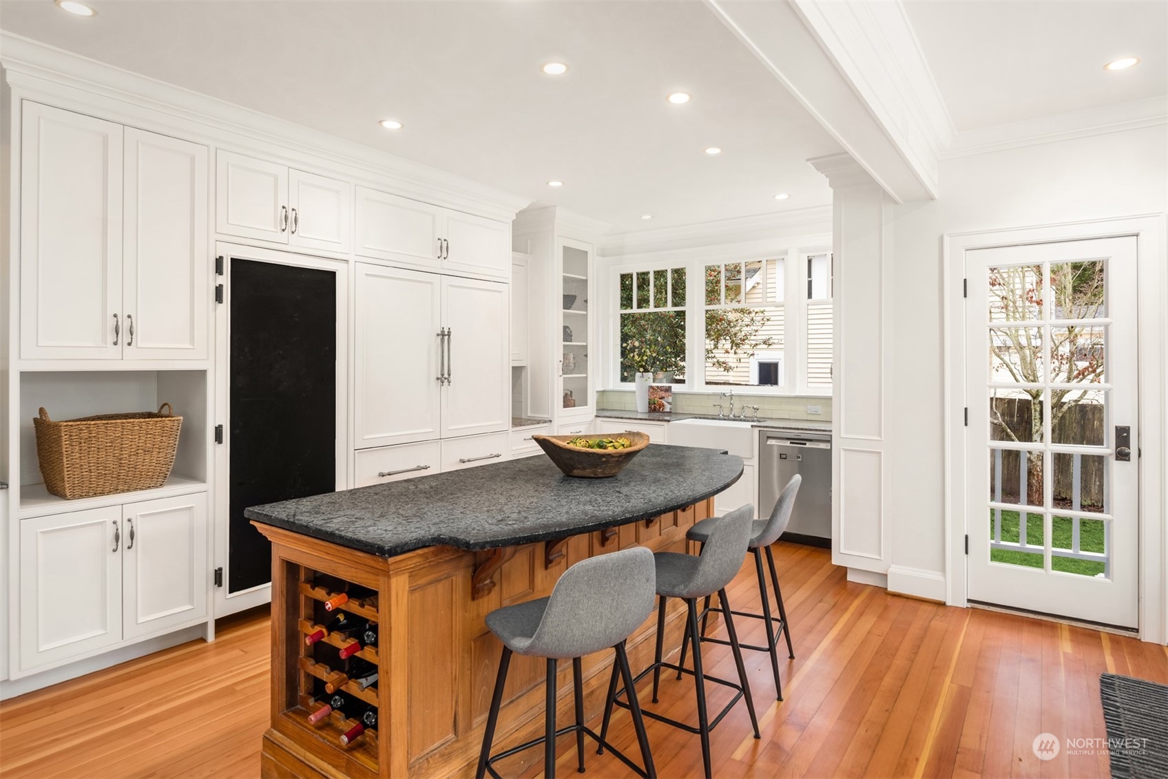 3206 East Terrace Street Seattle, WA 98122 - Photo 10 of 28 a kitchen with stainless steel appliances granite countertop a stove a refrigerator a sink a dining table and chairs