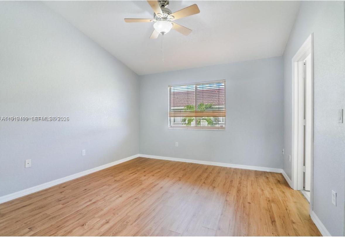 159 Hidden Ct Road Hollywood, FL 33023 - Photo 14 of 29 an empty room with wooden floor closet and fan