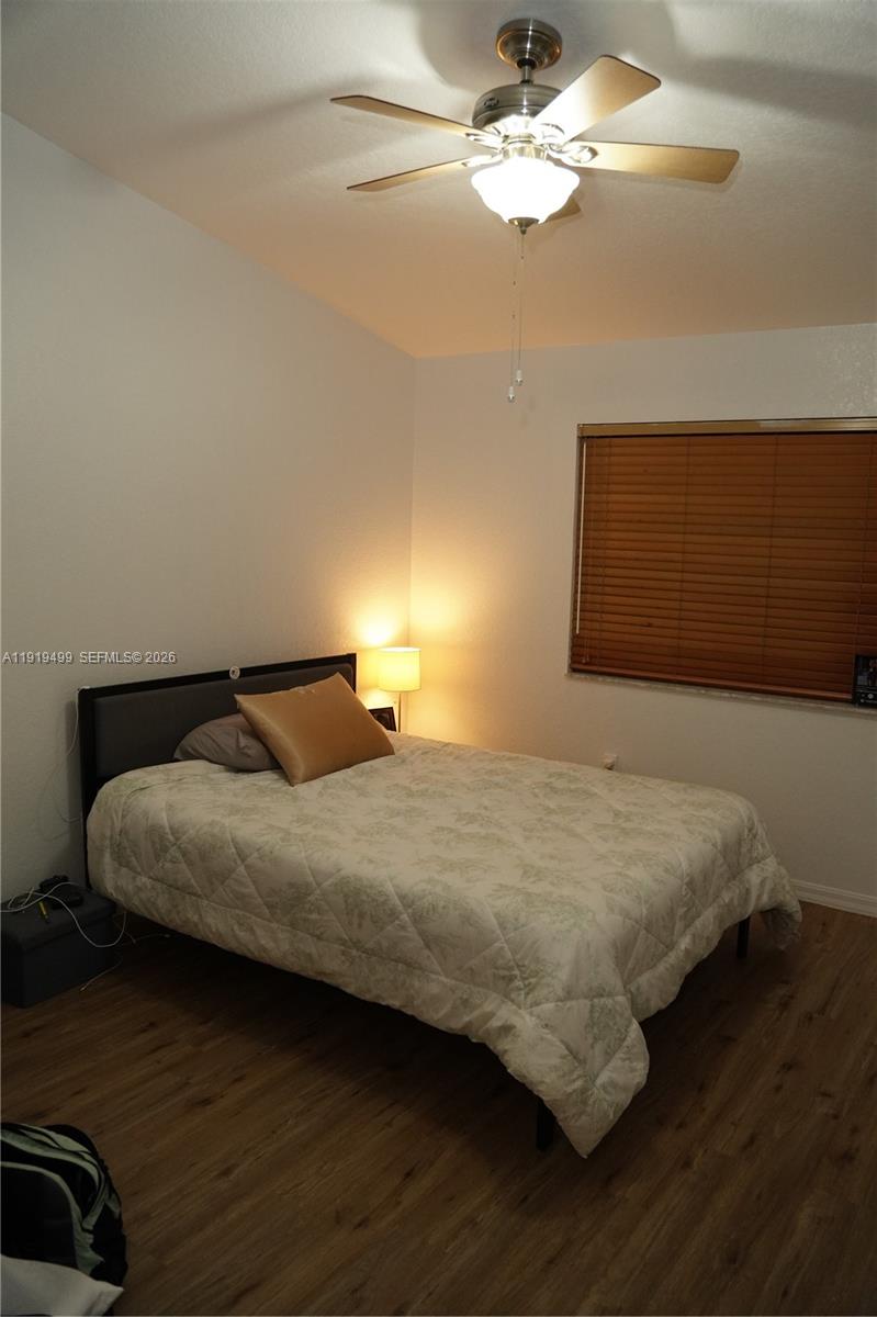 159 Hidden Ct Road Hollywood, FL 33023 - Photo 15 of 29 a bedroom with a bed and wooden floor