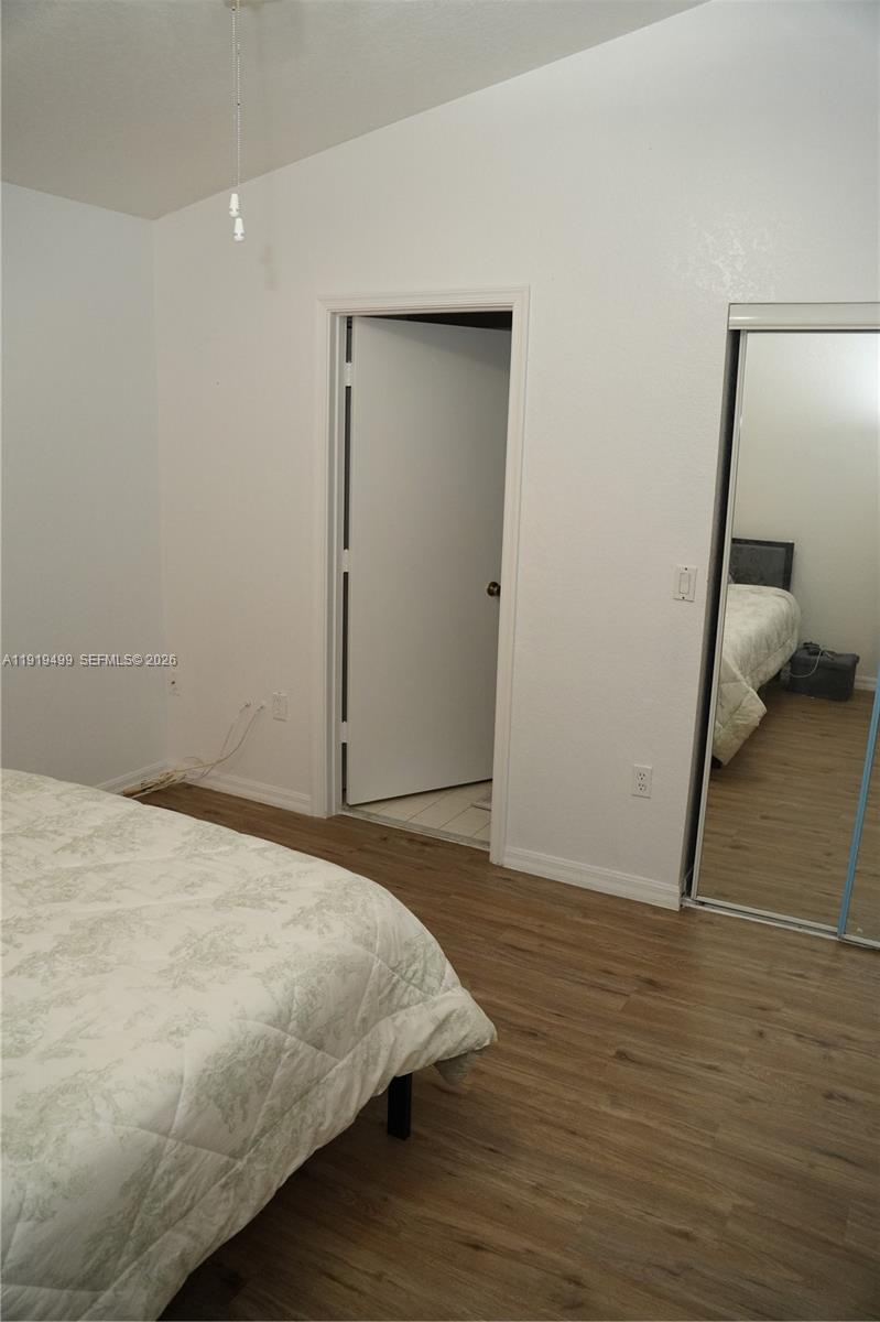 159 Hidden Ct Road Hollywood, FL 33023 - Photo 18 of 29 a bedroom with a bed and a walk in closet