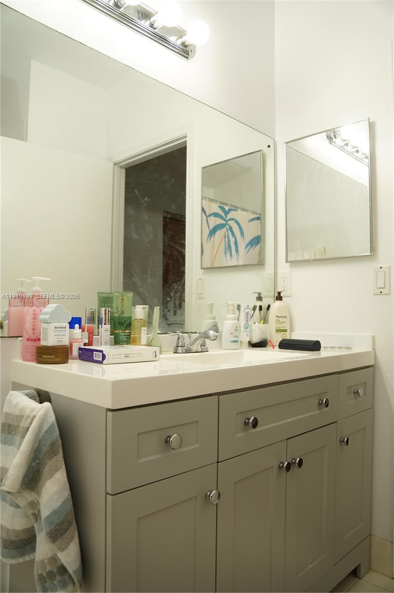 159 Hidden Ct Road Hollywood, FL 33023 - Photo 20 of 29 a bathroom with a sink and a mirror