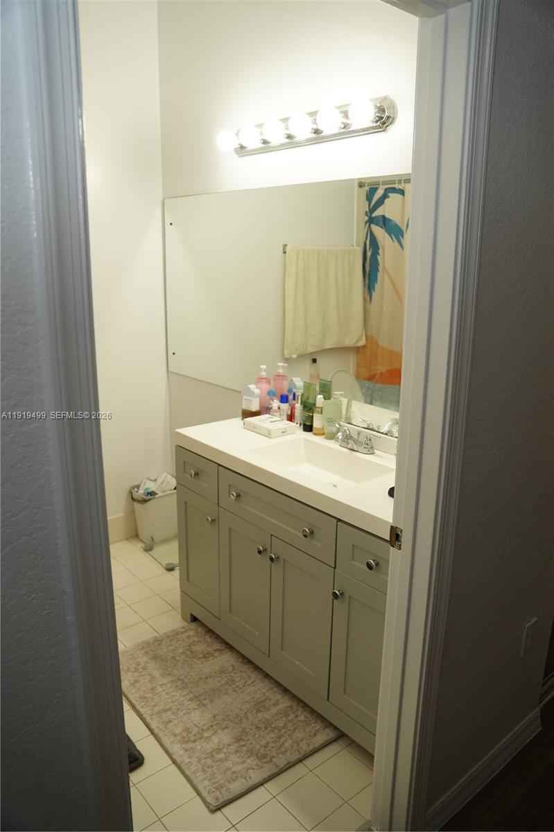 159 Hidden Ct Road Hollywood, FL 33023 - Photo 21 of 29 a bathroom with a granite countertop sink mirror and a toilet