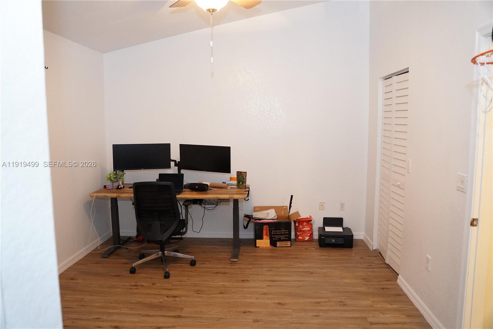 159 Hidden Ct Road Hollywood, FL 33023 - Photo 25 of 29 a view of a workspace with furniture and wooden floor