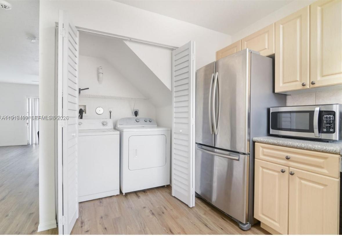 159 Hidden Ct Road Hollywood, FL 33023 - Photo 4 of 29 a kitchen with white cabinets white stainless steel appliances and wooden floors