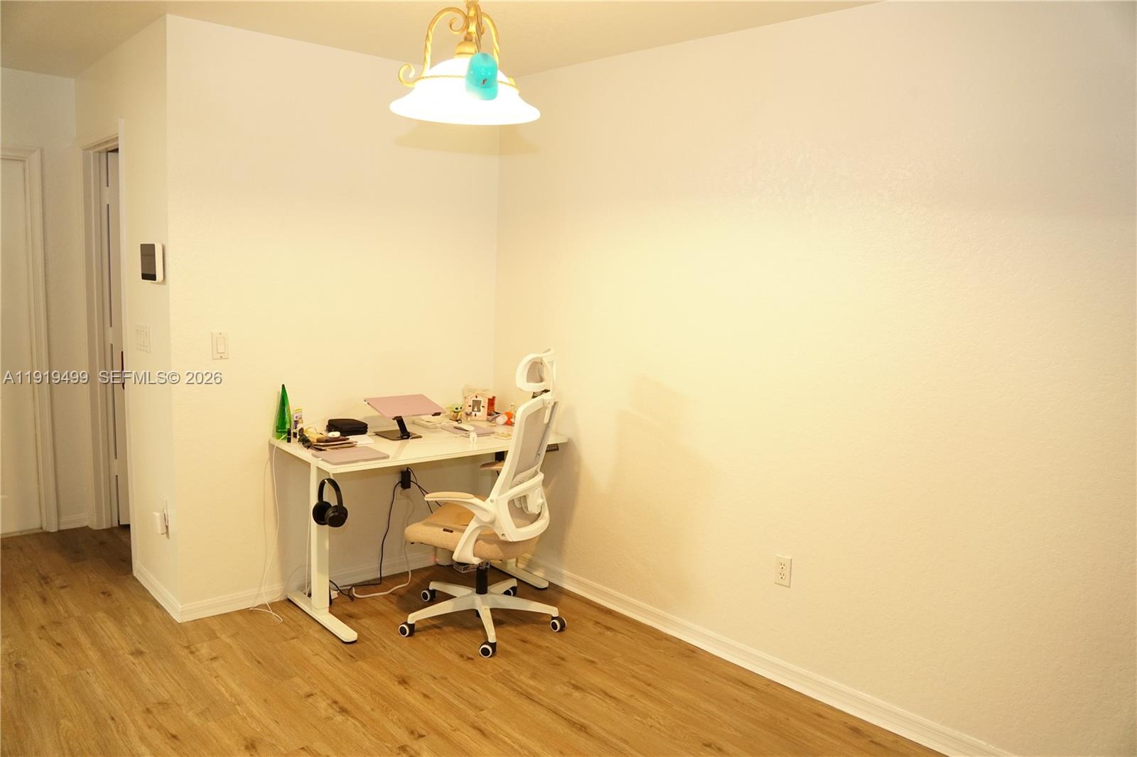 159 Hidden Ct Road Hollywood, FL 33023 - Photo 9 of 29 a view of a workspace with wooden floor
