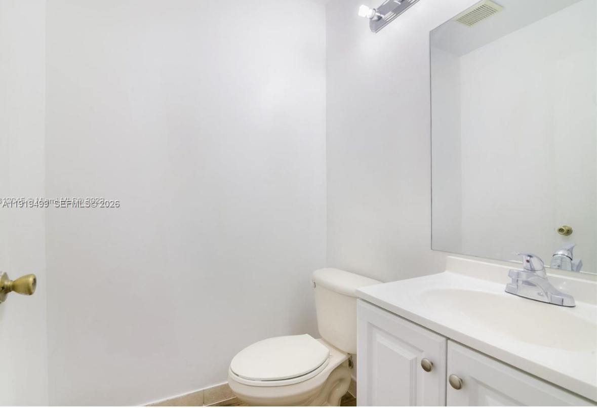 159 Hidden Ct Road Hollywood, FL 33023 - Photo 10 of 29 a bathroom with a sink a toilet and vanity