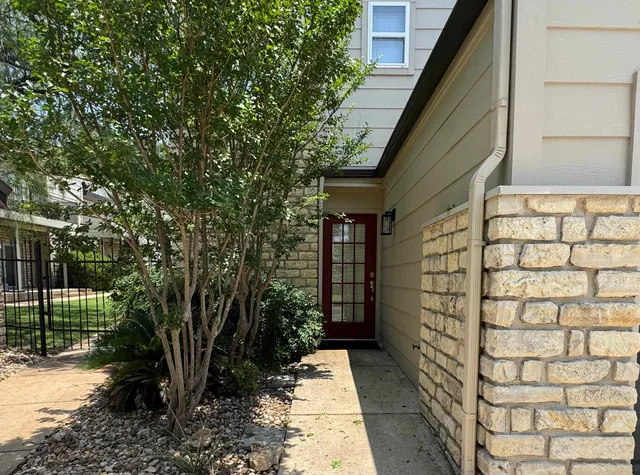 a view of brick house with a yard