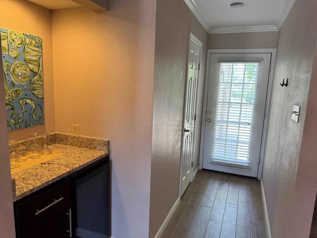a view of a bathroom with a sink and wooden floor