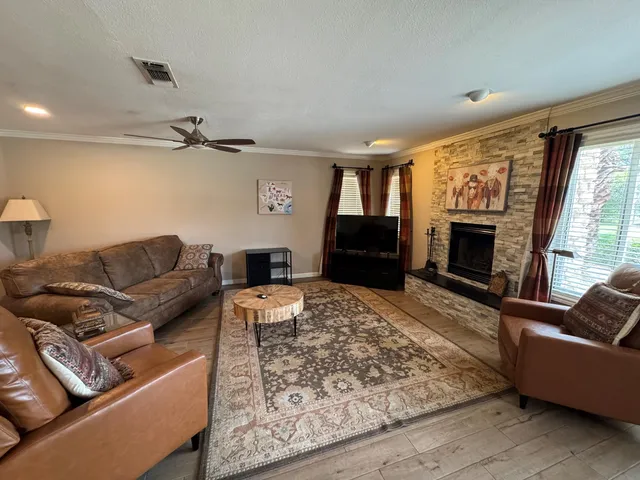 a living room with furniture and a fireplace