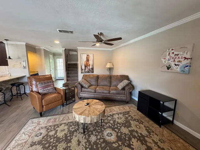 a living room with furniture and a rug