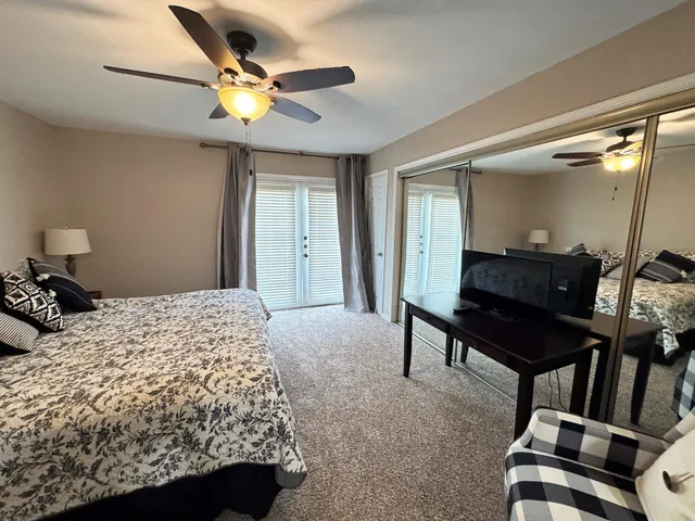 a bedroom with a bed a rug and a dresser