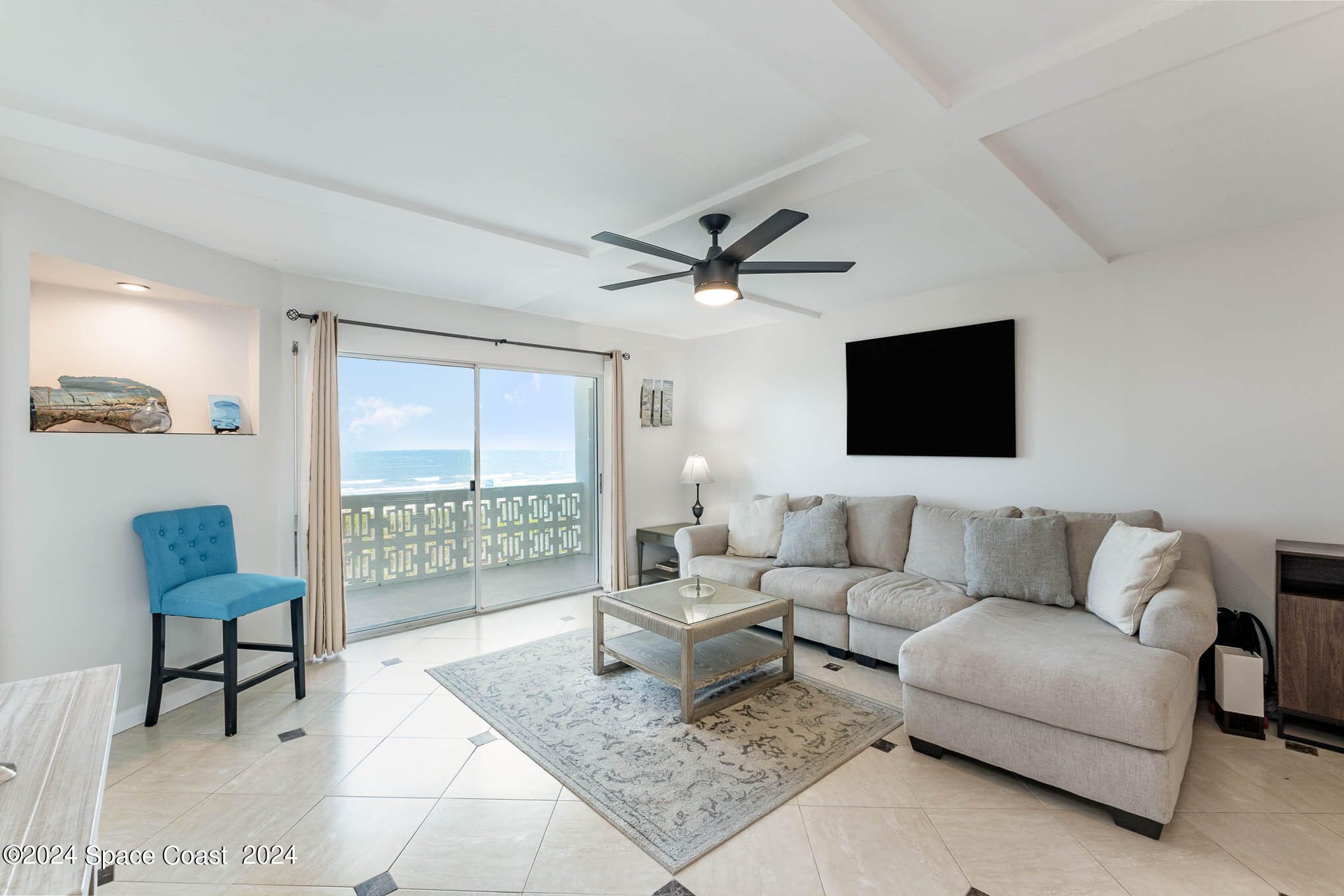 4800 Ocean Beach Boulevard, Unit 311 Cocoa Beach, FL 32931 - Photo 11 of 22 a living room with furniture and a flat screen tv