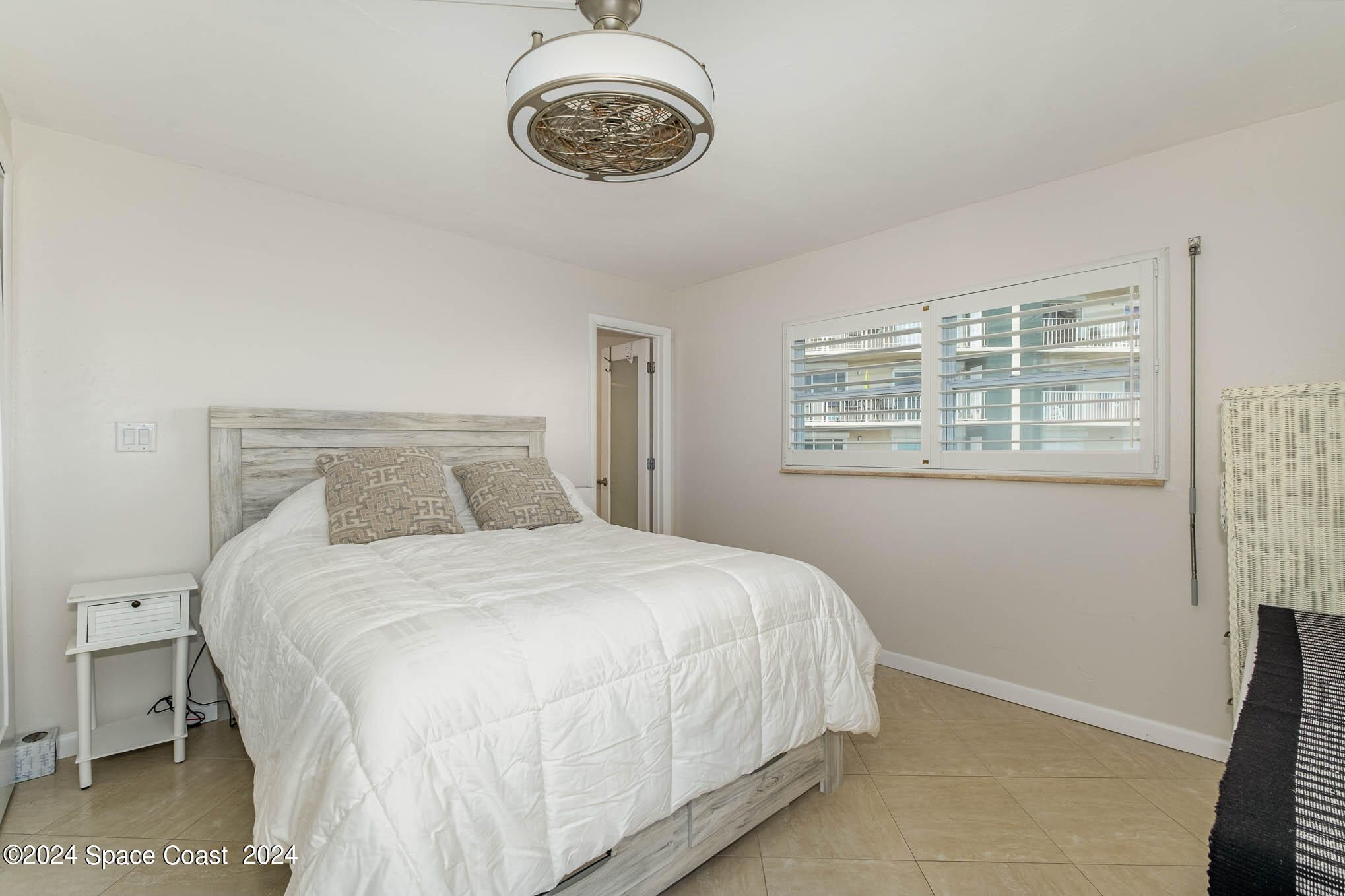 4800 Ocean Beach Boulevard, Unit 311 Cocoa Beach, FL 32931 - Photo 13 of 22 a bedroom with a bed and a window