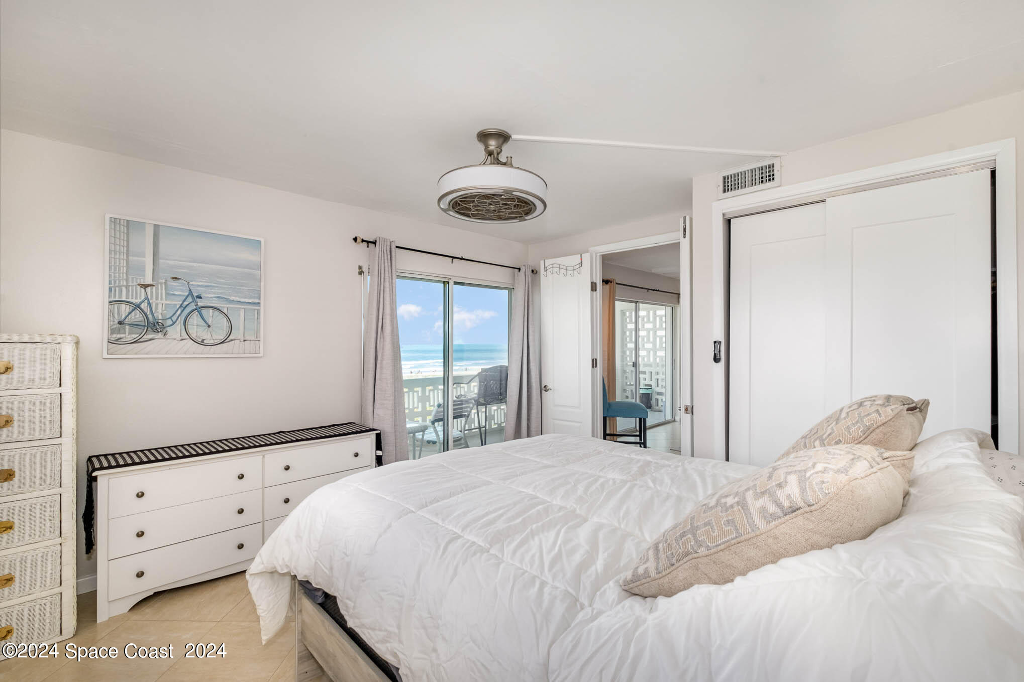 4800 Ocean Beach Boulevard, Unit 311 Cocoa Beach, FL 32931 - Photo 14 of 22 a bedroom with a large bed and a window