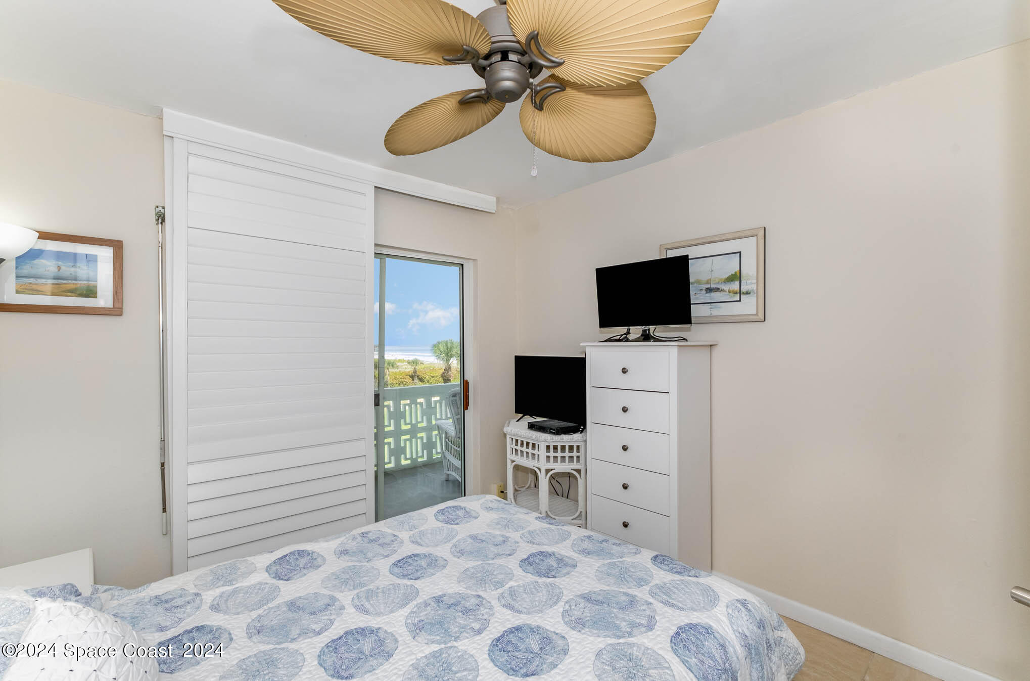 4800 Ocean Beach Boulevard, Unit 311 Cocoa Beach, FL 32931 - Photo 17 of 22 a view of a bedroom with a flat screen tv