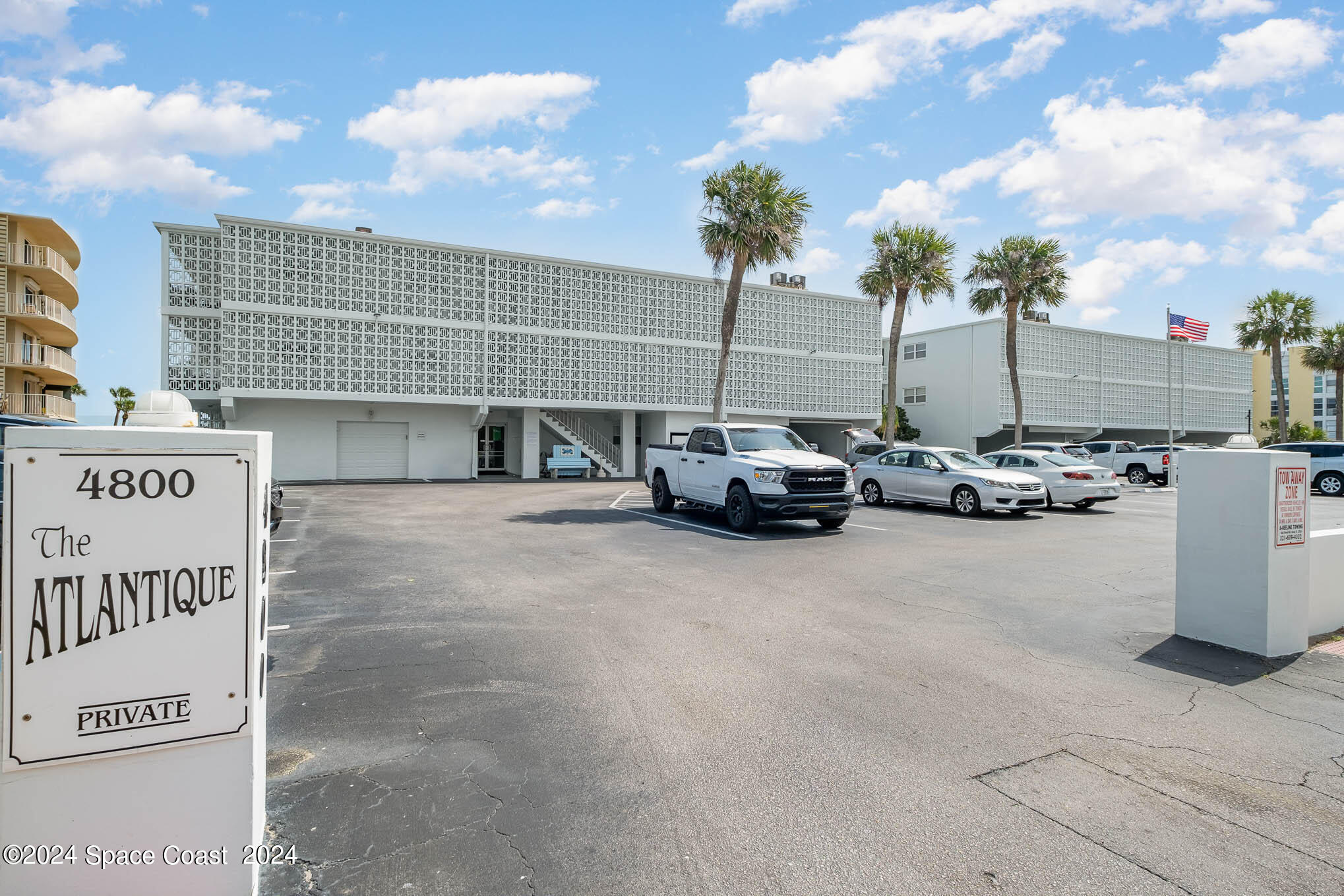 4800 Ocean Beach Boulevard, Unit 311 Cocoa Beach, FL 32931 - Photo 2 of 22 a car parked in front of a building