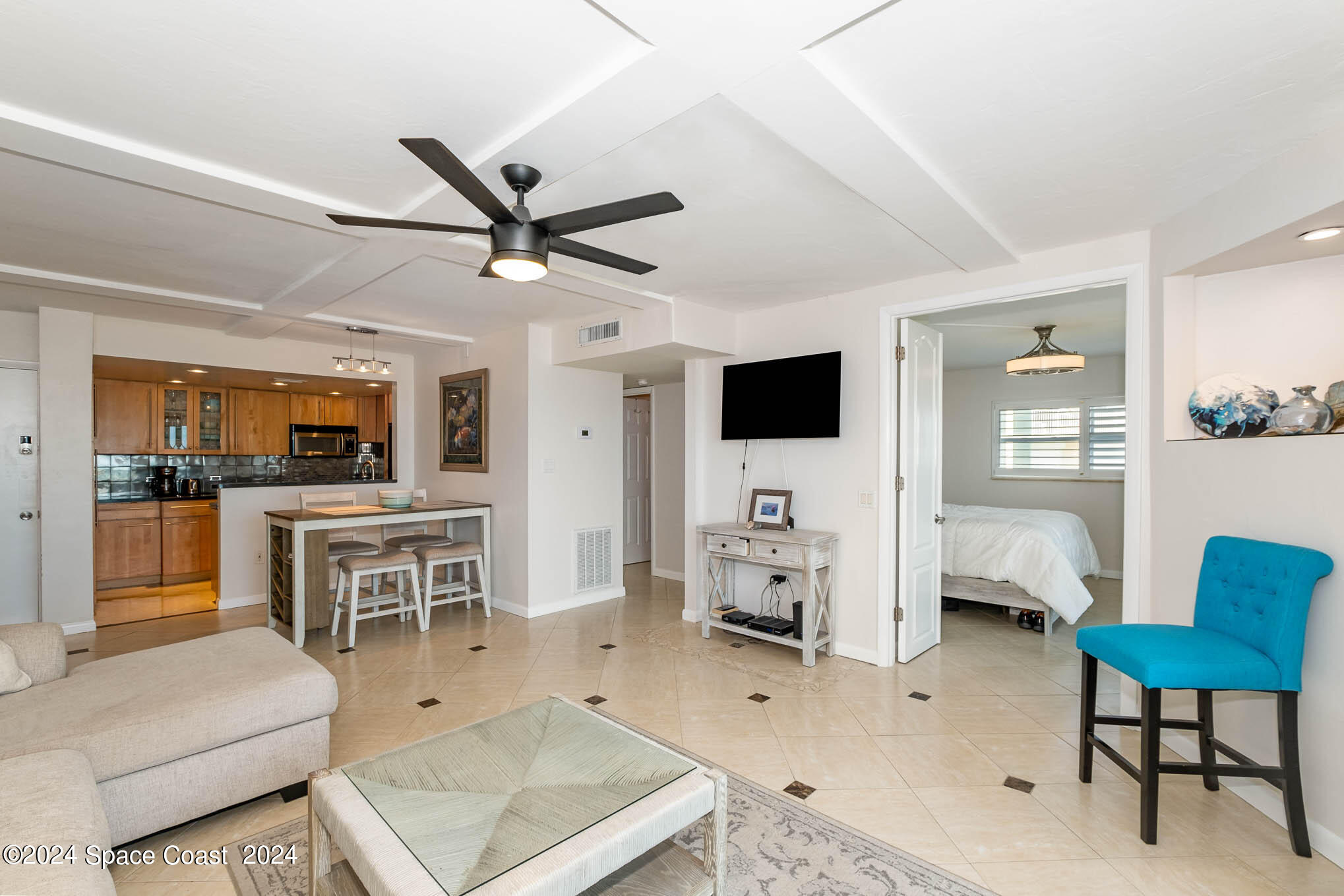 4800 Ocean Beach Boulevard, Unit 311 Cocoa Beach, FL 32931 - Photo 9 of 22 a living room with furniture and a flat screen tv