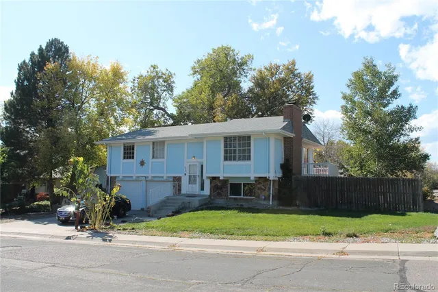 a view of a house with a yard and tree s