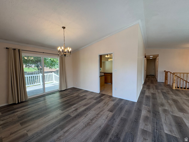 595 Meadowlark Road Orem, UT 84097 - Photo 6 of 87 Spacious room featuring wood-finish flooring, a contemporary chandelier, and direct access to an outdoor deck through a large sliding glass door