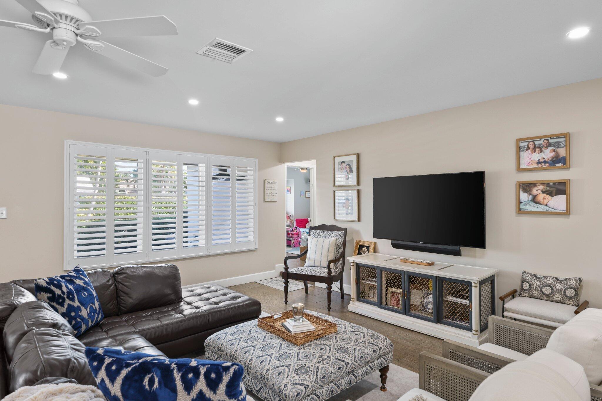 4141 Northeast 22nd Terrace Lighthouse Point, FL 33064 - Photo 11 of 46 a living room with furniture and a flat screen tv