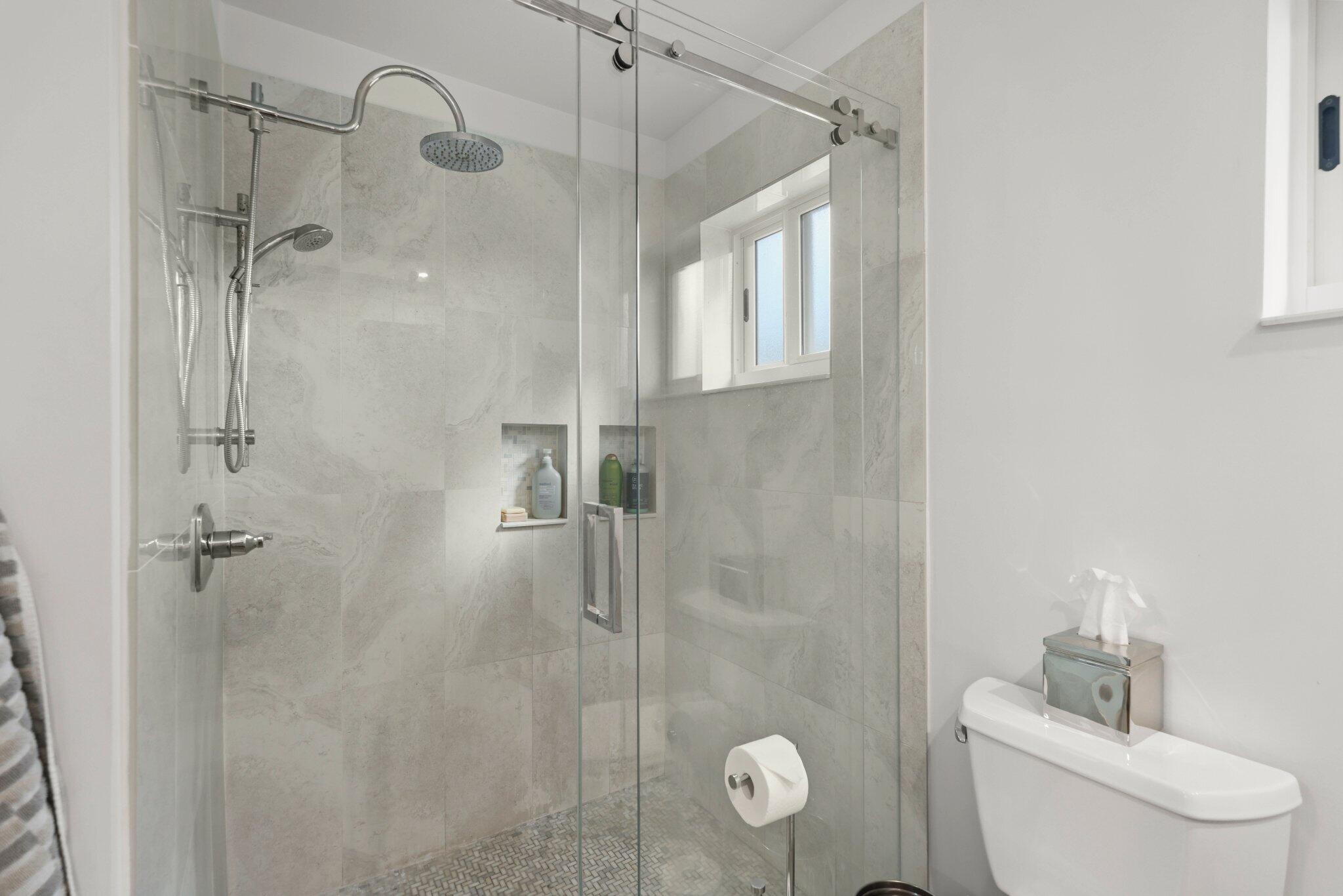 4141 Northeast 22nd Terrace Lighthouse Point, FL 33064 - Photo 22 of 46 a bathroom with a shower and toilet