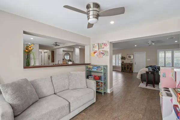 a living room with furniture and a chandelier