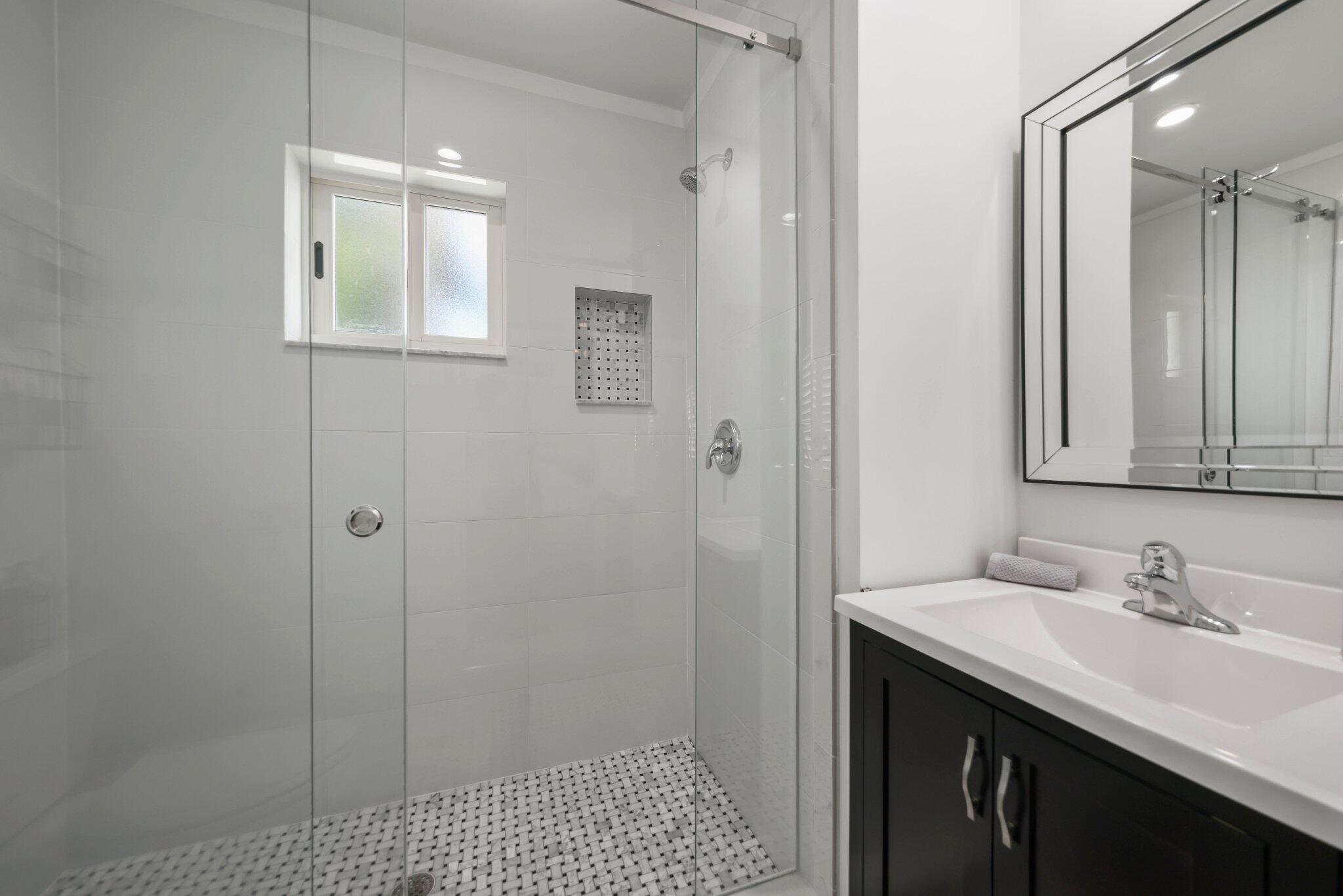 4141 Northeast 22nd Terrace Lighthouse Point, FL 33064 - Photo 24 of 46 a bathroom with a sink a toilet and shower