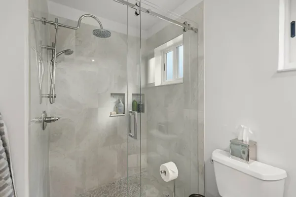 a bathroom with a shower and toilet