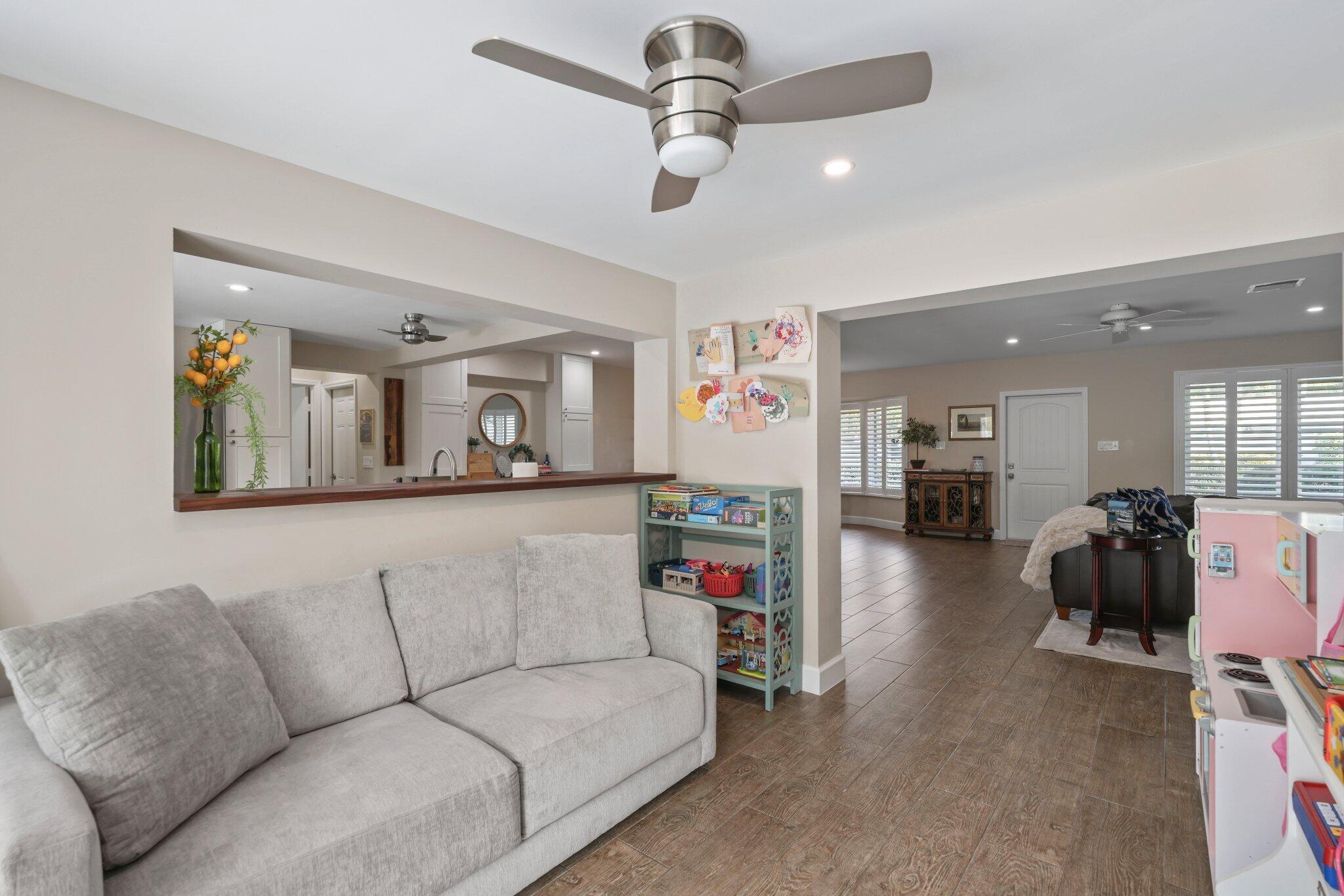 4141 Northeast 22nd Terrace Lighthouse Point, FL 33064 - Photo 28 of 46 a living room with furniture and a chandelier