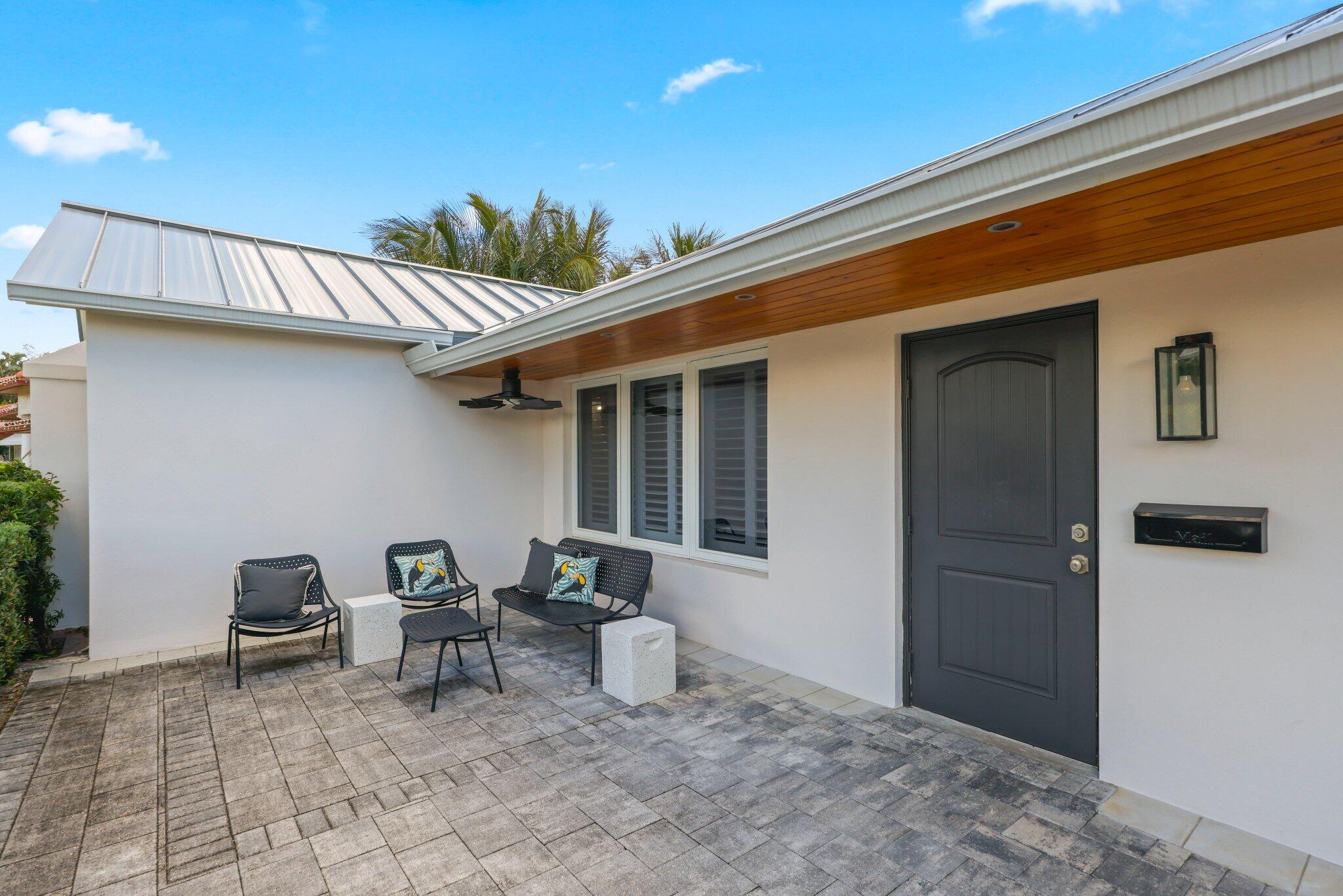 4141 Northeast 22nd Terrace Lighthouse Point, FL 33064 - Photo 3 of 46 a backyard of a house with table and chairs
