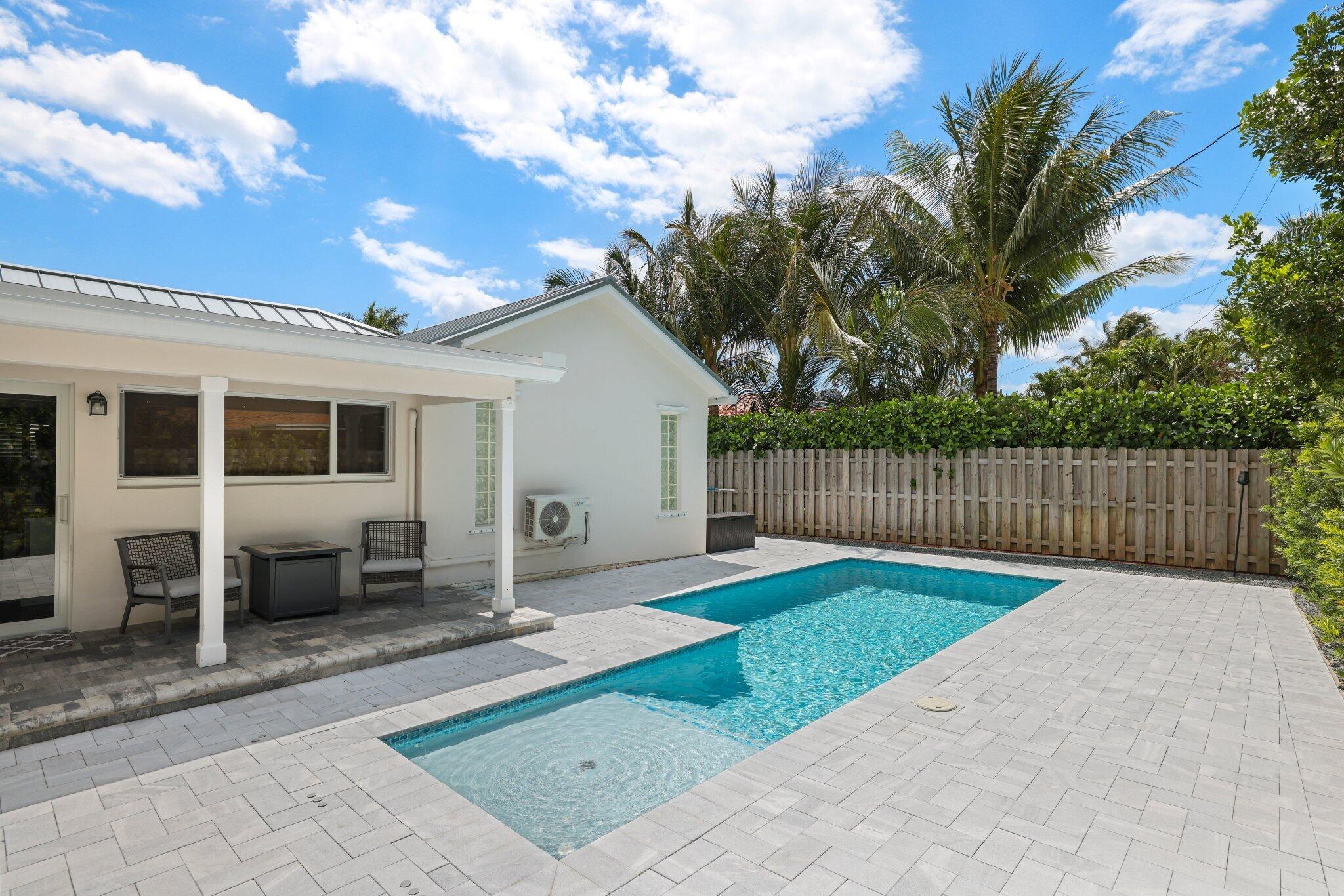 4141 Northeast 22nd Terrace Lighthouse Point, FL 33064 - Photo 31 of 46 a backyard of a house with seating space