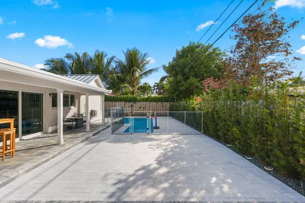 a view of house with backyard and sitting area