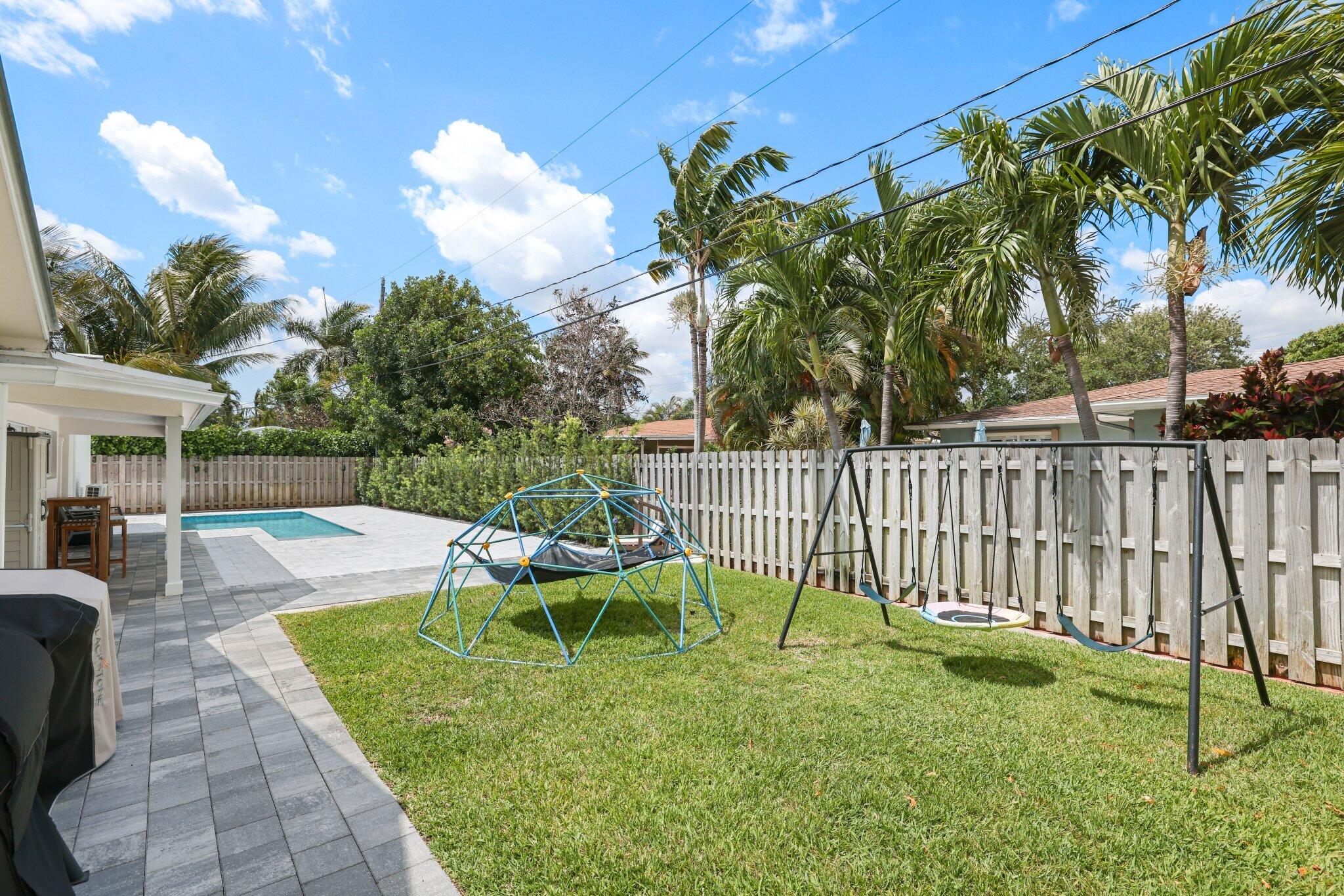 4141 Northeast 22nd Terrace Lighthouse Point, FL 33064 - Photo 35 of 46 a view of a house with backyard and sitting area