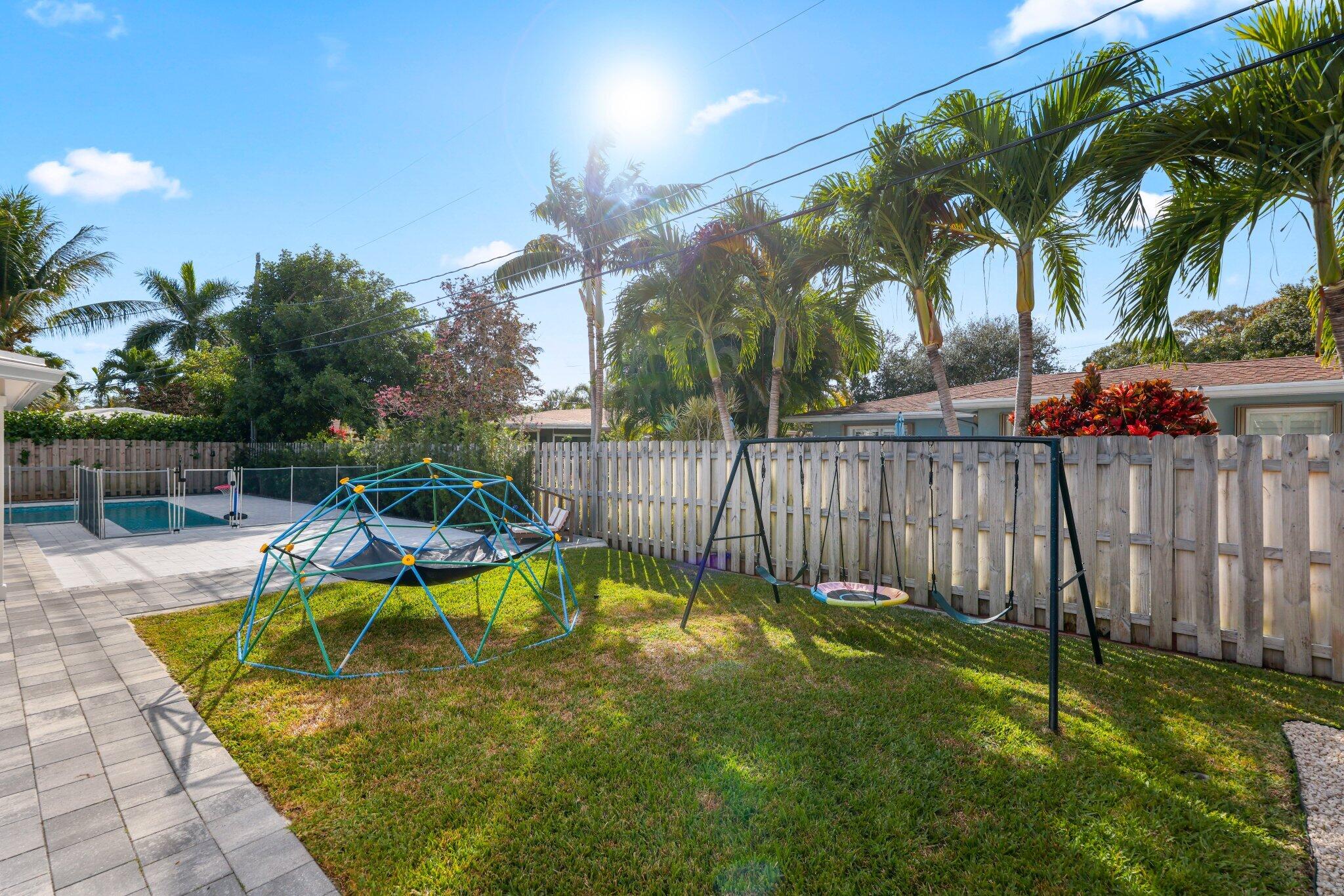 4141 Northeast 22nd Terrace Lighthouse Point, FL 33064 - Photo 37 of 46 a view of a backyard with swimming pool and sitting area
