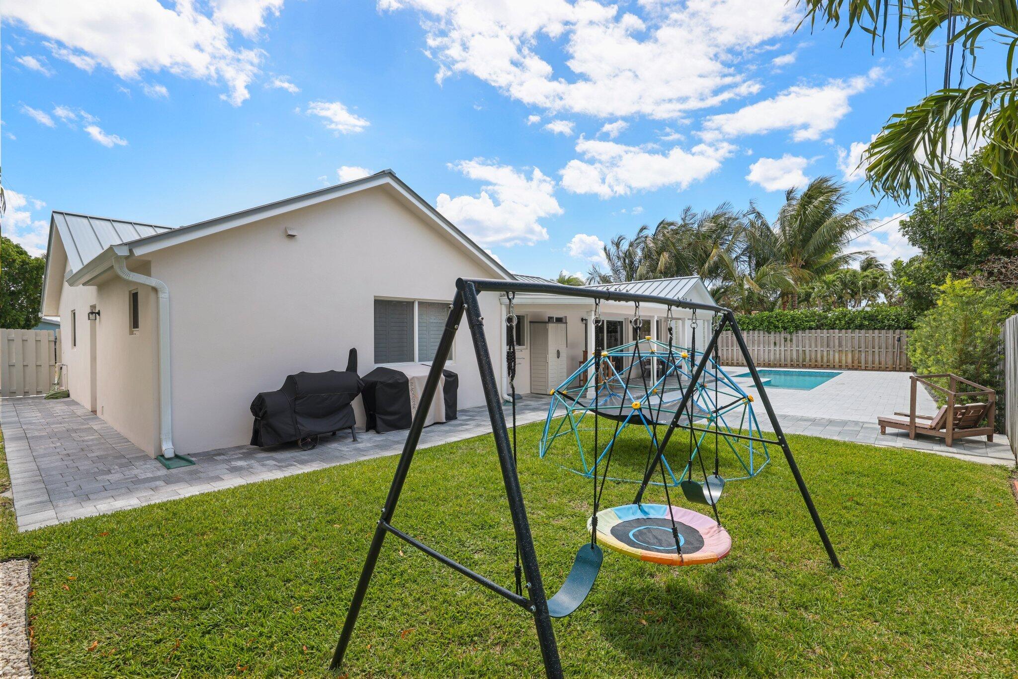 4141 Northeast 22nd Terrace Lighthouse Point, FL 33064 - Photo 38 of 46 a view of a backyard with a slide