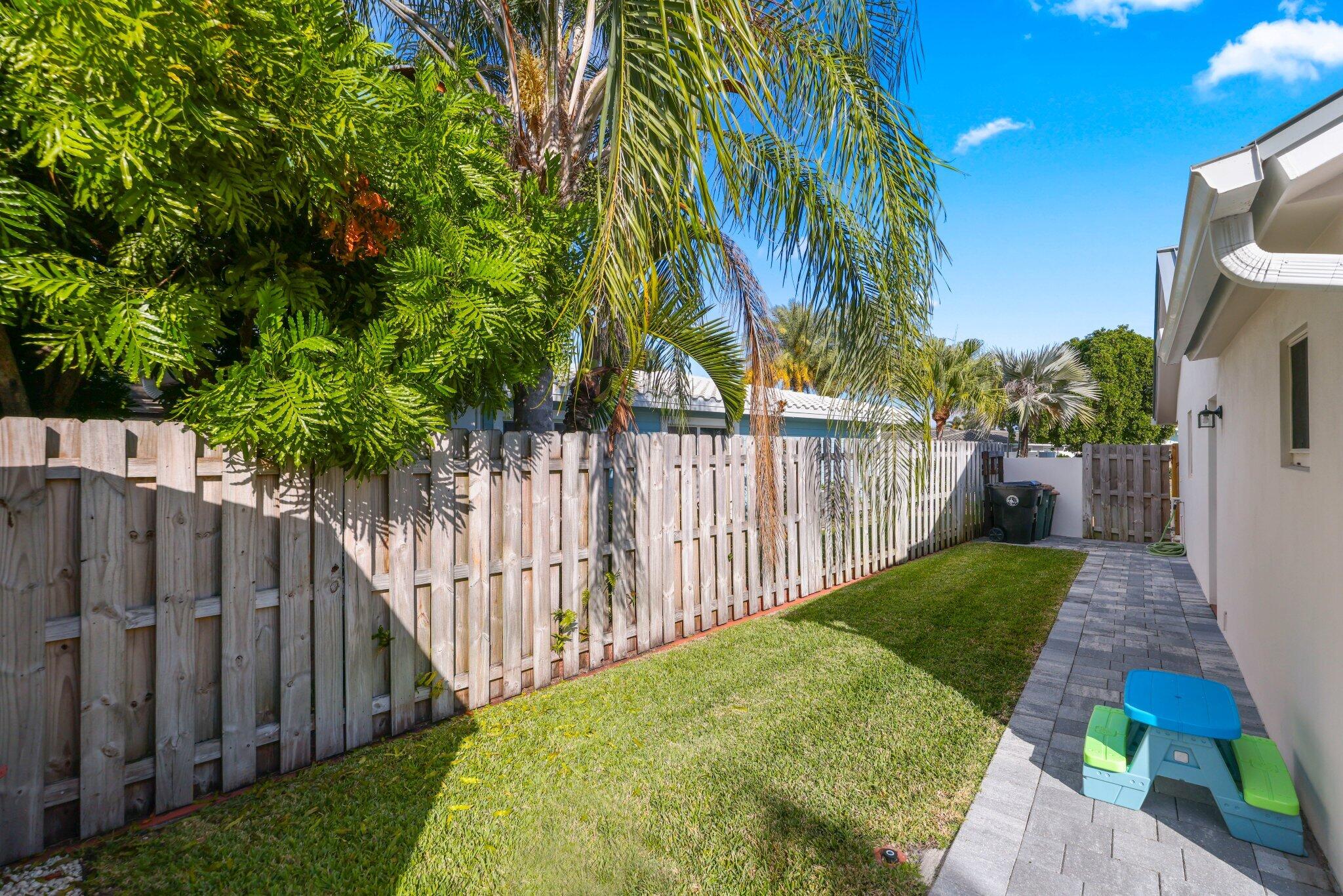 4141 Northeast 22nd Terrace Lighthouse Point, FL 33064 - Photo 39 of 46 a view of a backyard with wooden fence