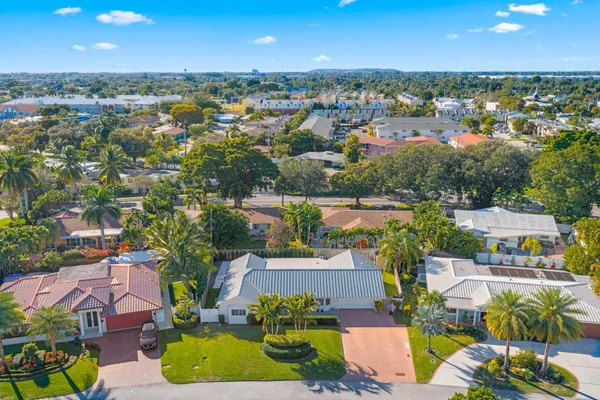 an aerial view of residential houses with outdoor space and swimming pool
