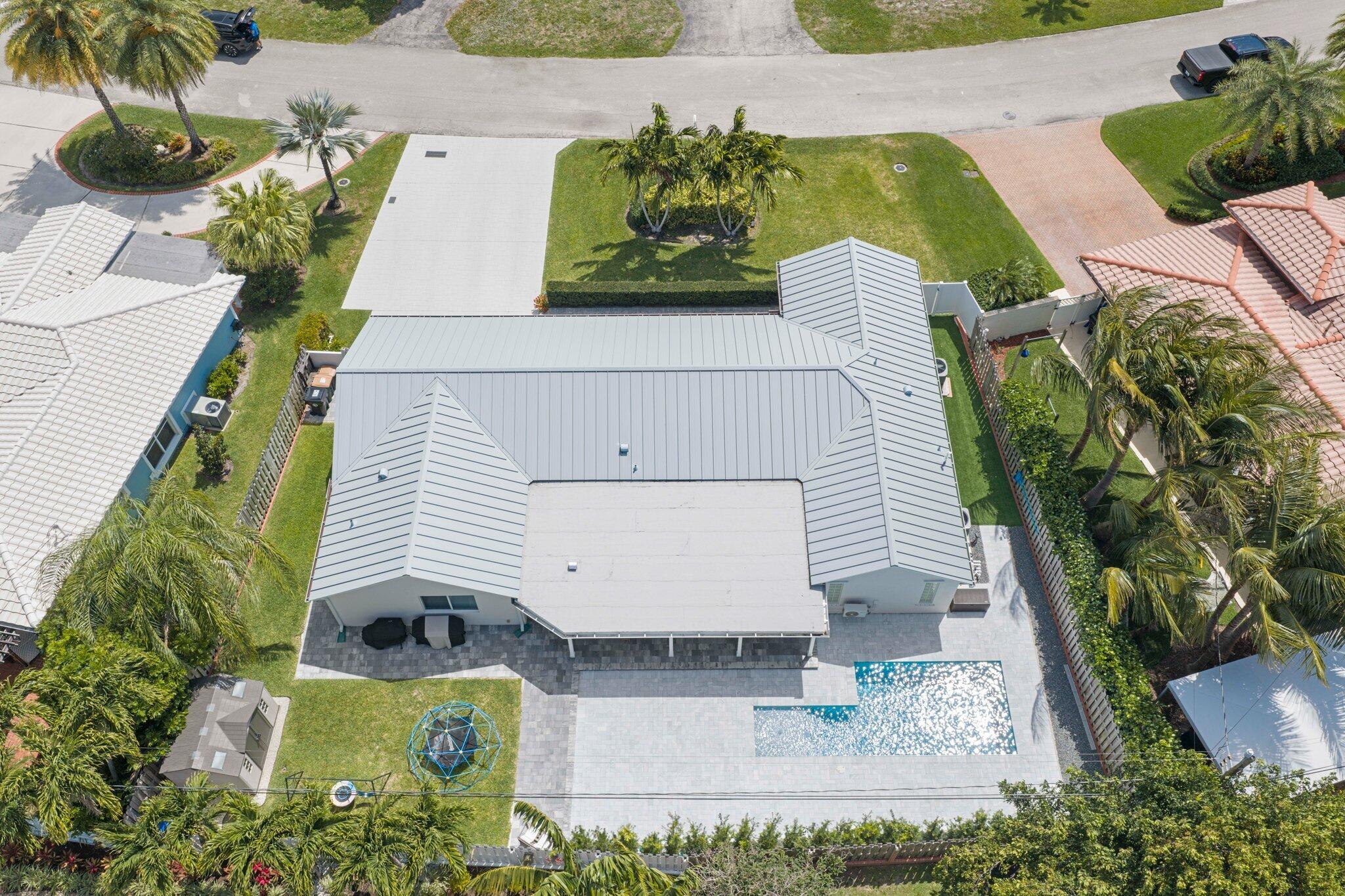 4141 Northeast 22nd Terrace Lighthouse Point, FL 33064 - Photo 41 of 46 a view of a swimming pool with potted plants