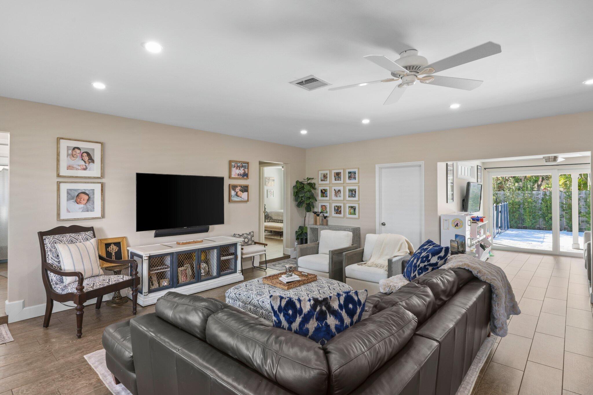 4141 Northeast 22nd Terrace Lighthouse Point, FL 33064 - Photo 10 of 46 a living room with furniture and a flat screen tv