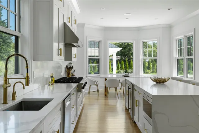 a kitchen with a sink a stove and cabinets