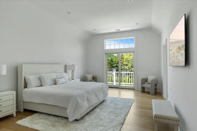 a bedroom with a bed and glass window