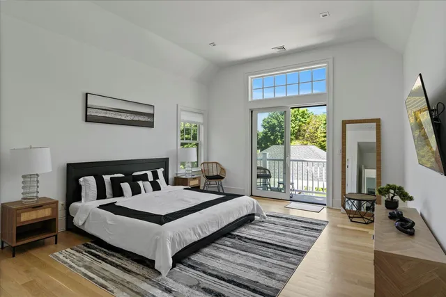 a bedroom with furniture and a large window