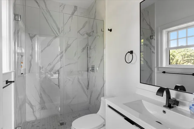 a bathroom with a sink toilet and shower