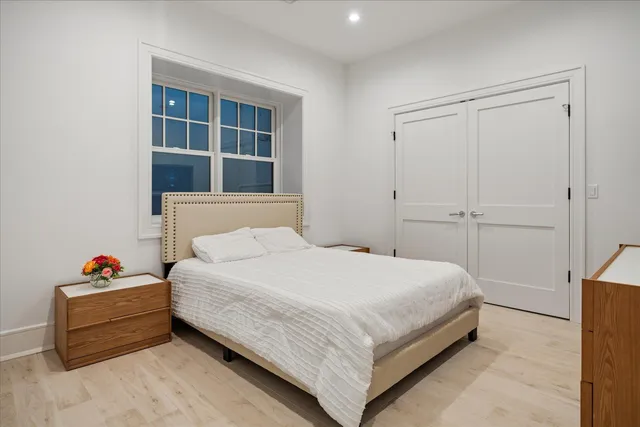 a bedroom with a bed and walk in closet