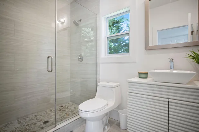 a bathroom with a sink toilet and shower