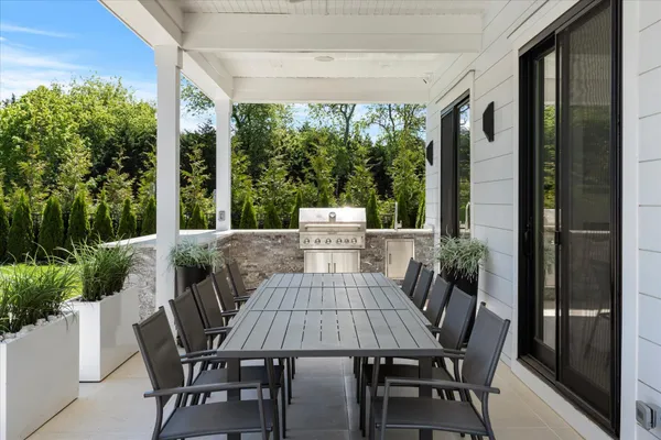 a view of a patio with a table chairs and a porch