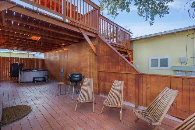 a view of deck with furniture and trees in the background